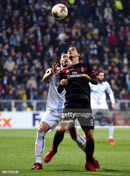 Milan forward Andre Silva vies with Rijeka's defender Josip Elez during the UEFA Europa League Group D football match between HNK Rijeka and AC Milan...