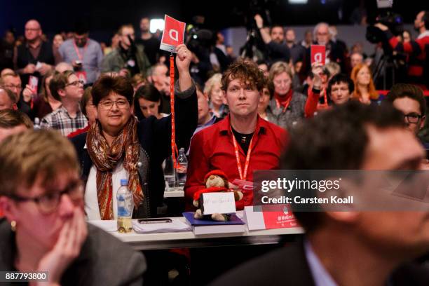 Delegates show the voting cards during the voting about coalition talks at the SPD federal party congress on December 7, 2017 in Berlin, Germany. SPD...