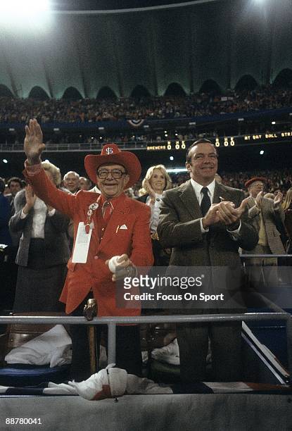 St Louis Cardinal Gussie Busch waves to the crowd before throwing out the first pitch for game one of the 1982 World Series between the Milwaukee...