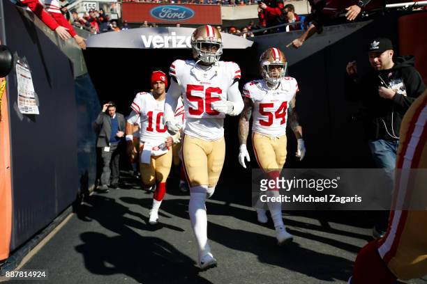 Jimmy Garoppolo, Reuben Foster and Cassius Marsh of the San Francisco 49ers take the field prior to the game against the Chicago Bears at Soldier...