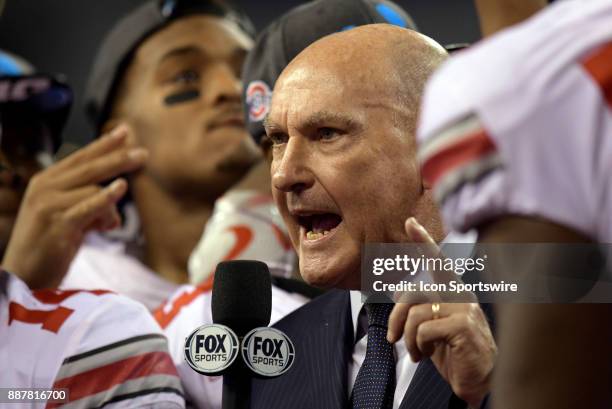 Big Ten commissioner Jim Delany presents the Championship trophy to the Ohio State Buckeyes at the conclusion of the Big Ten Championship football...