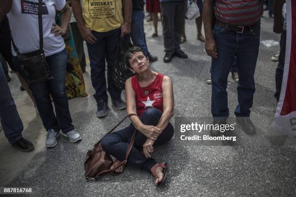 Suporter listens while Luiz Inacio Lula da Silva, former president of Brazil, not pictured, speaks during a presidential pre-campaign rally outside...