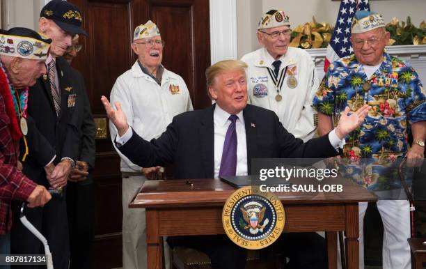 President Donald Trump speaks with Pearl Harbor survivors during an event marking National Pearl Harbor Remembrance Day in the Roosevelt Room at the...