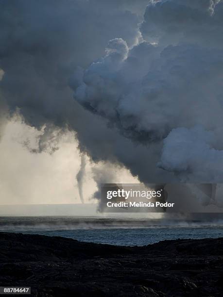 watersprout & smoke-twister at lava-entry point - kalapana stock pictures, royalty-free photos & images