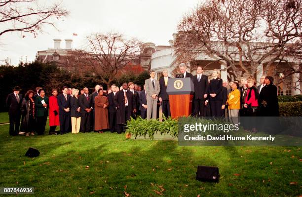 Surrounded by Congressional Democrats, President Bill Clinton reacts to being impeached by the House of Representatives outside of the oval office in...