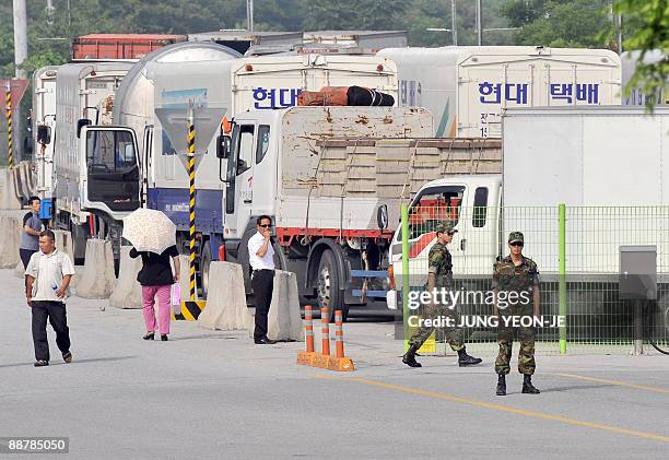 South Korean vehicles wait to head for the Kaesong Industrial Complex at a check point of the inter-Korean transit office in Paju on July 2, 2009. A...