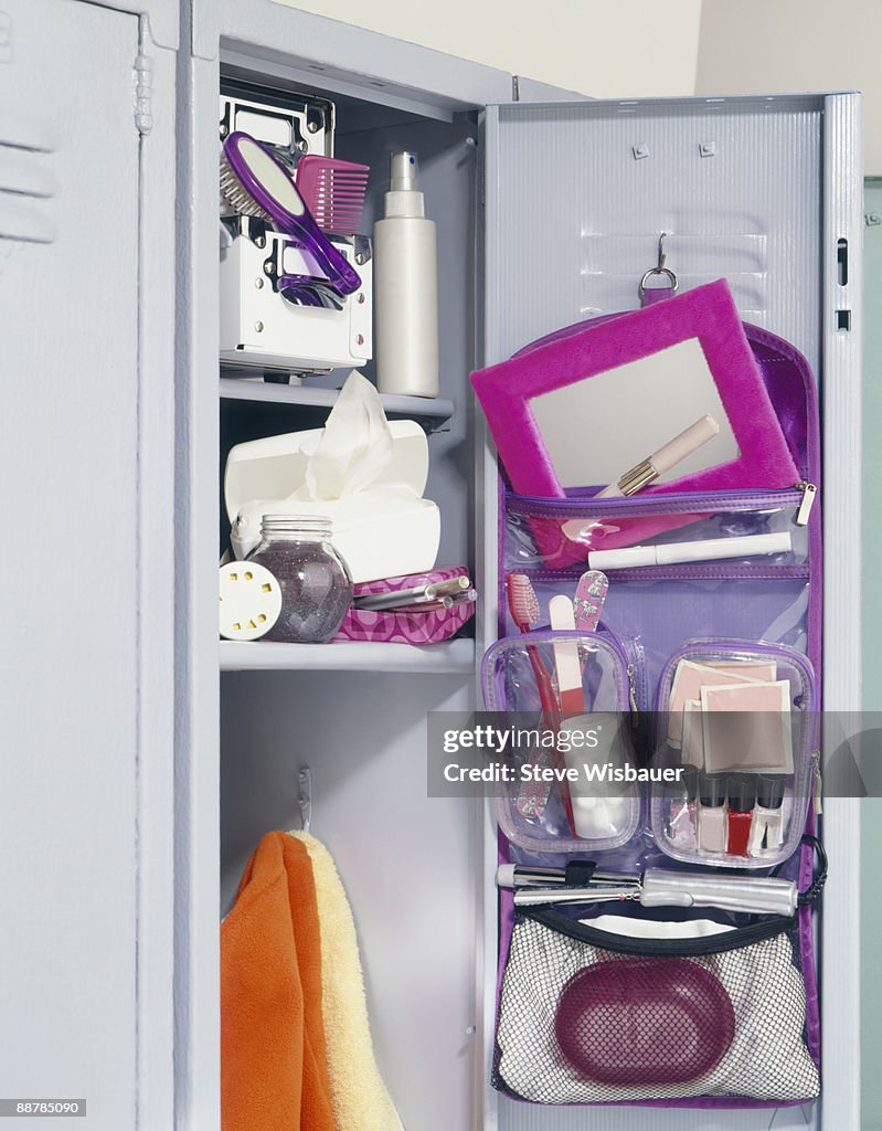 Girl's school locker overflowing with makeup 