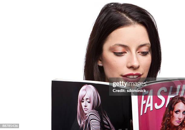 beautiful woman reading a magazine - holding magazine stock-fotos und bilder