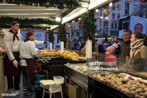 Customer buy "Langos" an Hungarian speciality at the Vorosmarty Square Christmas market on December 7, 2017 in Budapest, Hungary. The traditional...