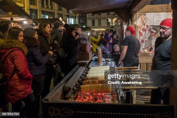 Customers buy the traditional Hungarian Chimney Cake at Vorosmarty Square Christmas market on December 7, 2017 in Budapest, Hungary. The traditional...