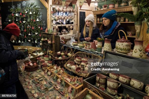 Woman buys some traditional Hungarian pottery at the Vorosmarty Square Christmas market on December 7, 2017 in Budapest, Hungary. The traditional...