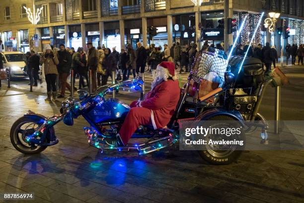 Man dressed as Father Christmas poses for a picture in the city centre on December 7, 2017 in Budapest, Hungary. The traditional Christmas market and...