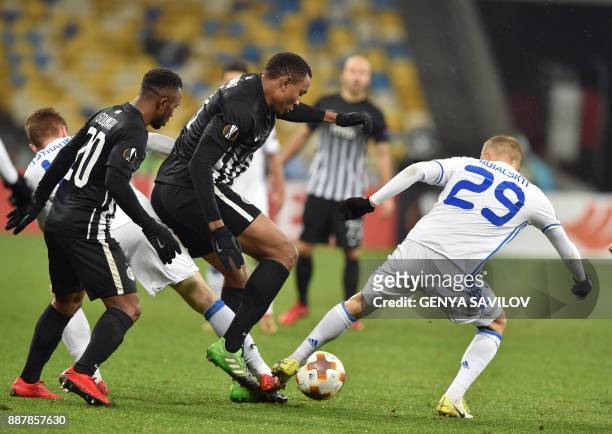 Dynamo's Vitaliy Buyalskiy vies with Partizan's Leandre Tawamba and Seydouba Soumah during the UEFA Europa League group stage football match between...