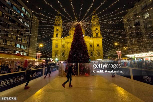 Children skate in front of Saint Stephen Basilica on December 7, 2017 in Budapest, Hungary. The traditional Christmas market and lights will stay...