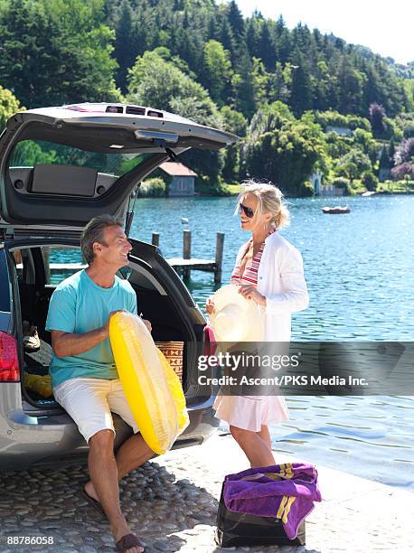 couple blow up air mattress on car tailgate - lake orta stock pictures, royalty-free photos & images