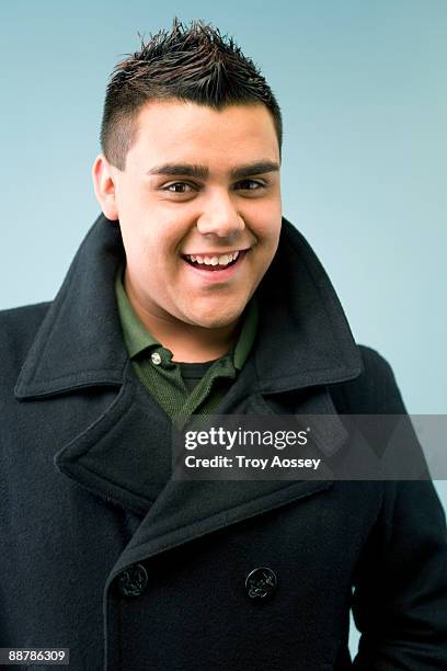 young man smiling wearing pea coat - spiky hair stock pictures, royalty-free photos & images