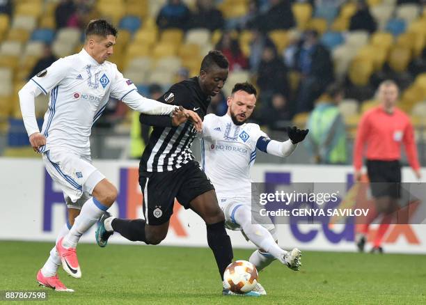 Partizan's Seydouba Soumah vies with Dynamo's Mykola Morozyuk and Yevhen Khacheridi during the UEFA Europa League group stage football match between...