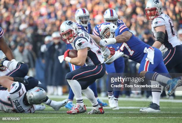 Rex Burkhead of the New England Patriots avoids a tackle by Lorenzo Alexander of the Buffalo Bills during NFL game action at New Era Field on...