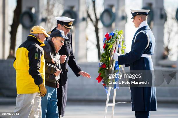 National Park Service volunteer escorts Retired Air Force Staff Sgt. Bill Hare as he places a wreath during a ceremony held by the Friends of the...