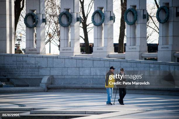 National Park Service volunteer escorts Retired Army Col. Fred Clinton to the wreath laying ceremony held by the Friends of the National World War II...