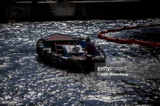 Person operates a boat near the Port of Santos in Santos, Brazil, on Wednesday, Oct. 4, 2017. The port complex is a 3-square-mile microcosm of a...