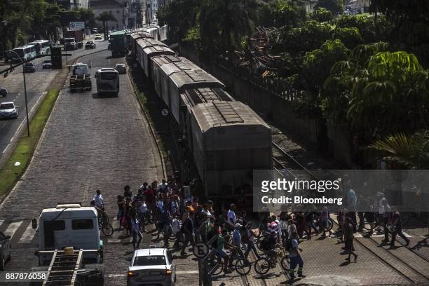 Pedestrians pass in front of train near the Port of Santos in Santos, Brazil, on Thursday, Oct. 5, 2017. The port complex is a 3-square-mile...