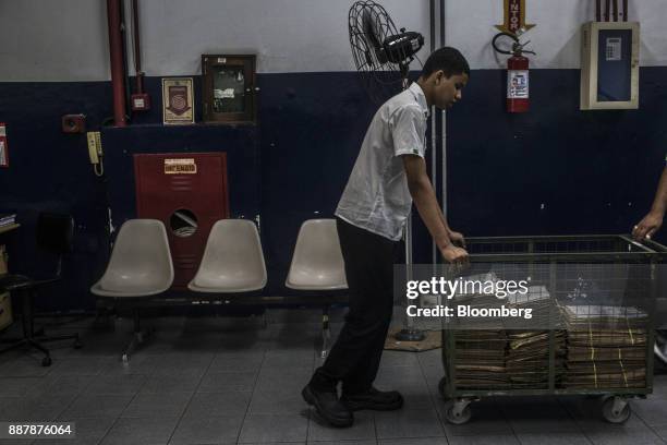 An employee transports documents inside a customs facility at the Port of Santos in Santos, Brazil, on Wednesday, Oct. 4, 2017. The port complex is a...
