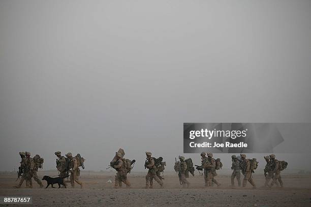 Marines from 2nd Marine Expeditionary Brigade, RCT 2nd Battalion 8th Marines Echo Co.walk to their helicopter during the start of Operation Khanjari...