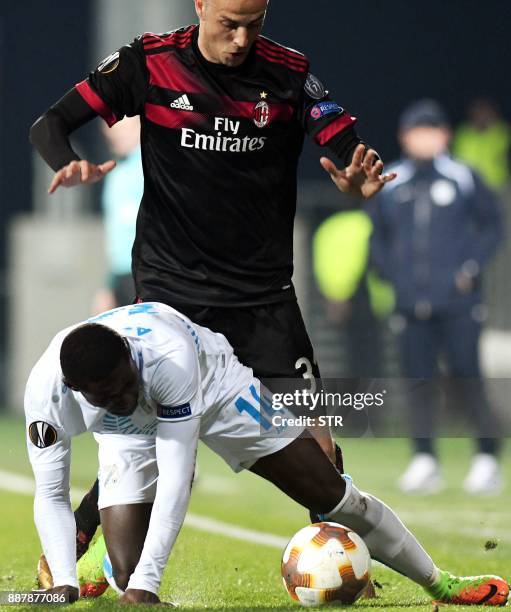 Milan's midfielder Luca Antonelli fights for the ball with Rijeka's forward Maxwell Acosty during the UEFA Europa League Group D football match...