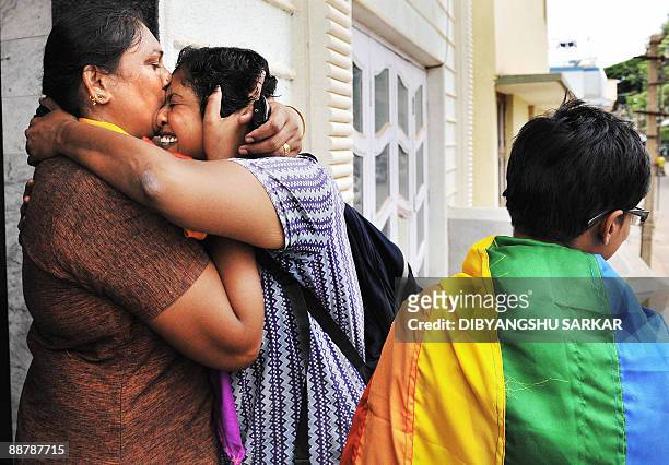 Members of the Indian homosexual community embrace each other as they celebrate the New Delhi High Court ruling decriminalising gay sex, in Bangalore...