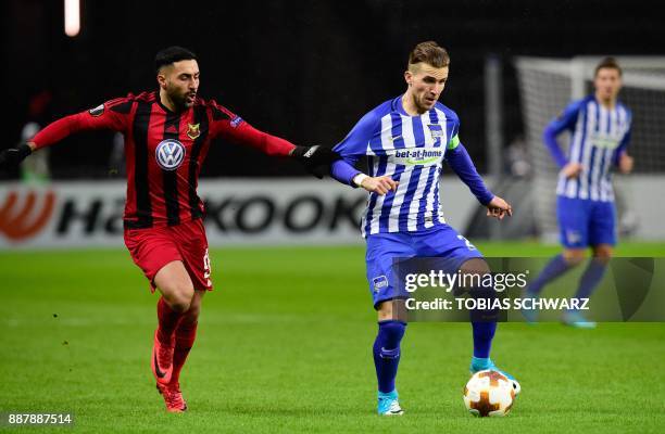 Berlin's Slovakian defender Peter Pekarik and Ostersund's Saman Ghoddos vie for the ball during the UEFA Europa League group J football match Hertha...