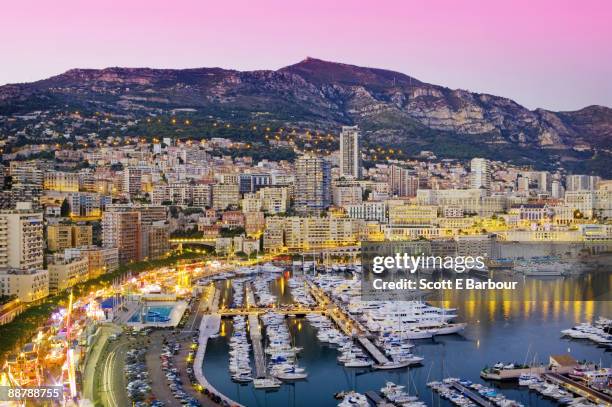 marina and cityscape of monaco at dusk - monaco marina stock pictures, royalty-free photos & images