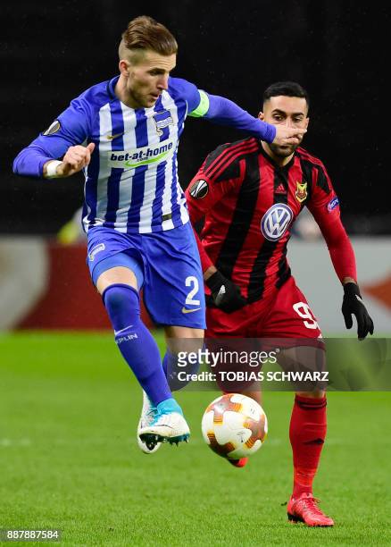 Berlin's Slovakian defender Peter Pekarik and Ostersund's Saman Ghoddos vie for the ball during the UEFA Europa League group J football match Hertha...