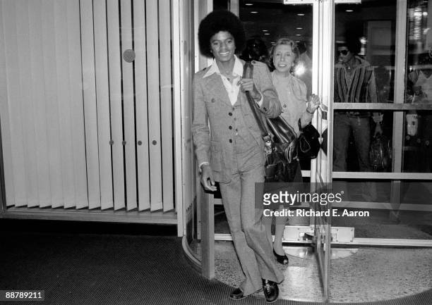 Michael Jackson walking through a revolving door in a hotel in New York in 1977.