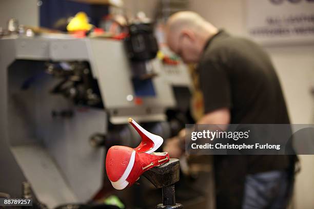 Cobbler, David Taylor works on a pair of designer shoes in his workshop in Deansgate on July 2, 2009 in Manchester, England. Since the start of the...