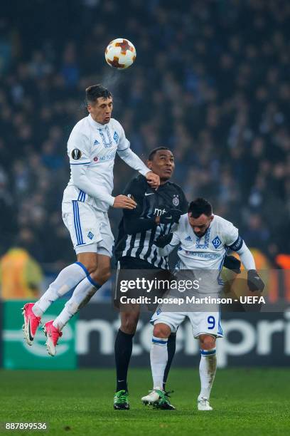 Yevhen Khacheridi and Mykola Morozyuk of FC Dynamo Kyiv competes with Leandre Tawamba of FK Partizan Belgrade during the UEFA Europa League group B...