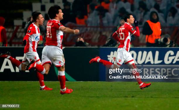 Crvena Zvezda's Slavoljub Srnic celebrates after scoring a goal with teammates Filip Stojkovic and Branko Jovicic during the UEFA Europa League...