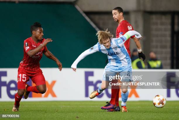 Zulte's Kingsley Madu and Lazio's Dusan Basta vie for the ball during the UEFA Europa League Group K football match between Zulte Waregem and SS...