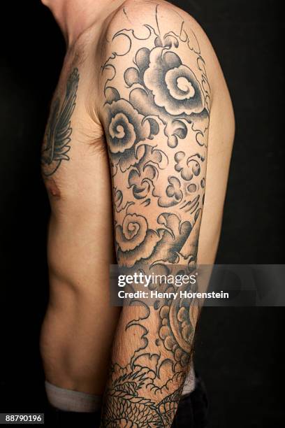 man with tattoos on arms and chest. - tattoo arm stockfoto's en -beelden