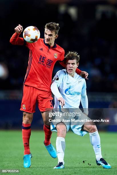 Aleksandr Kokorin of Zenit St. Petersburg duels for the ball with Diego Llorente of Real Sociedad during the UEFA Europa League group L football...