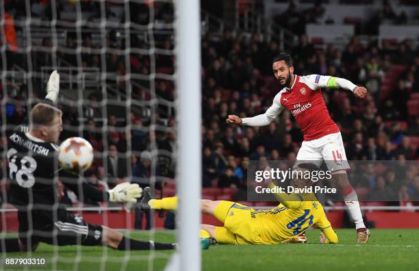 Theo Walcott scores Arsenal's 2nd goal under pressure from Mirko Ivanic of Bate during the UEFA Europa League group H match between Arsenal FC and...