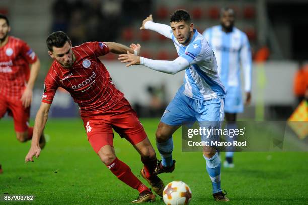 Luca Crecco of SS Lazio compete for the ball with Sandy Walsh of SV Zulte Waregem during the UEFA Europa League group K match between SV Zulte...