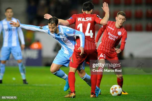 Alessandro Murgia of SS Lazio compete for the ball with Sandy Walsh of SV Zulte Waregem during the UEFA Europa League group K match between SV Zulte...