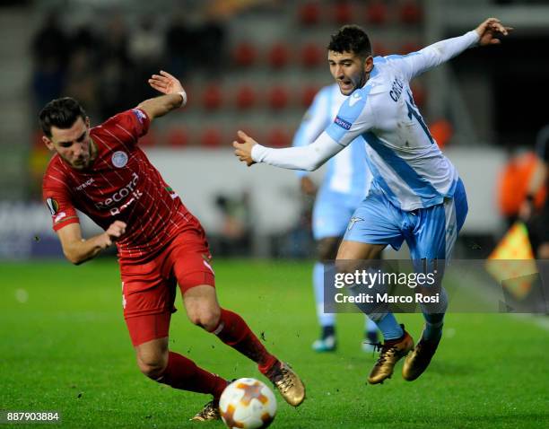 Luca Crecco of SS Lazio compete for the ball with Sandy Walsh of SV Zulte Waregem during the UEFA Europa League group K match between SV Zulte...