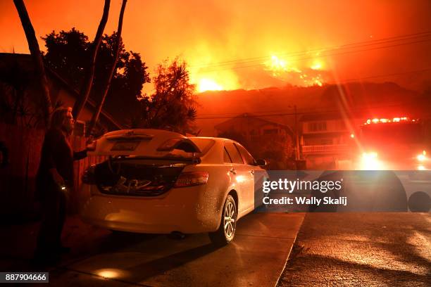 Resident packs her car as the Thomas Fire approaches the town of La Conchita early Thursday morning.