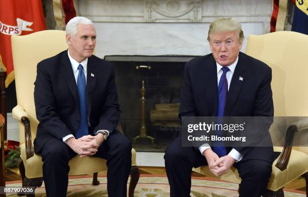 President Donald Trump, right, speaks as U.S. Vice President Mike Pence, listens during a meeting with congressional leadership in the Oval Office of...