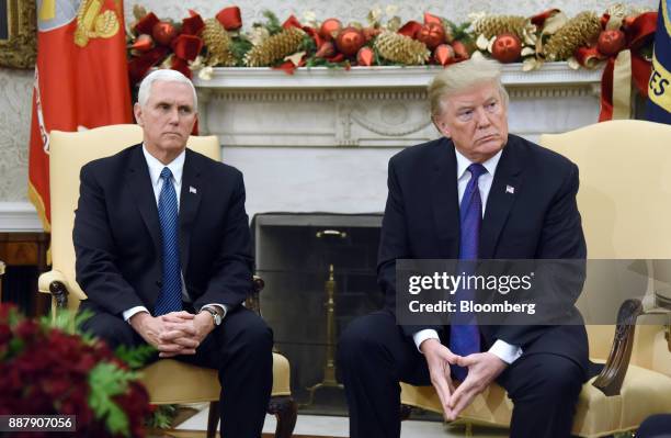 President Donald Trump, right, and U.S. Vice President Mike Pence, listen during a meeting with congressional leadership in the Oval Office of the...