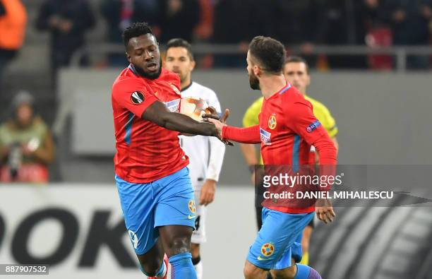 Harlem Gnohere of Steaua Bucharest celebrates with his teammate Gabriel Enache after he scored the 1-2 against of Energy Investment Lugano during the...