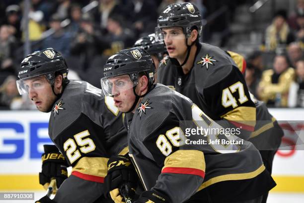 Stefan Matteau, Nate Schmidt, and Luca Sbisa of the Vegas Golden Knights await a face-off against the Anaheim Ducks during the game at T-Mobile Arena...