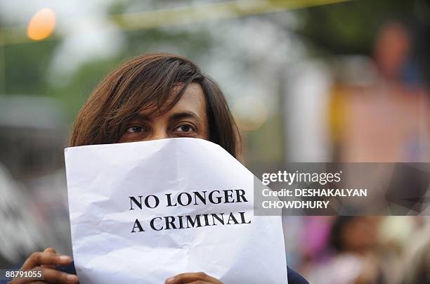 An Indian gay activist holds a poster during celebrations over the New Delhi High Court ruling decriminalising gay sex, in Kolkata on July 2, 2009. A...